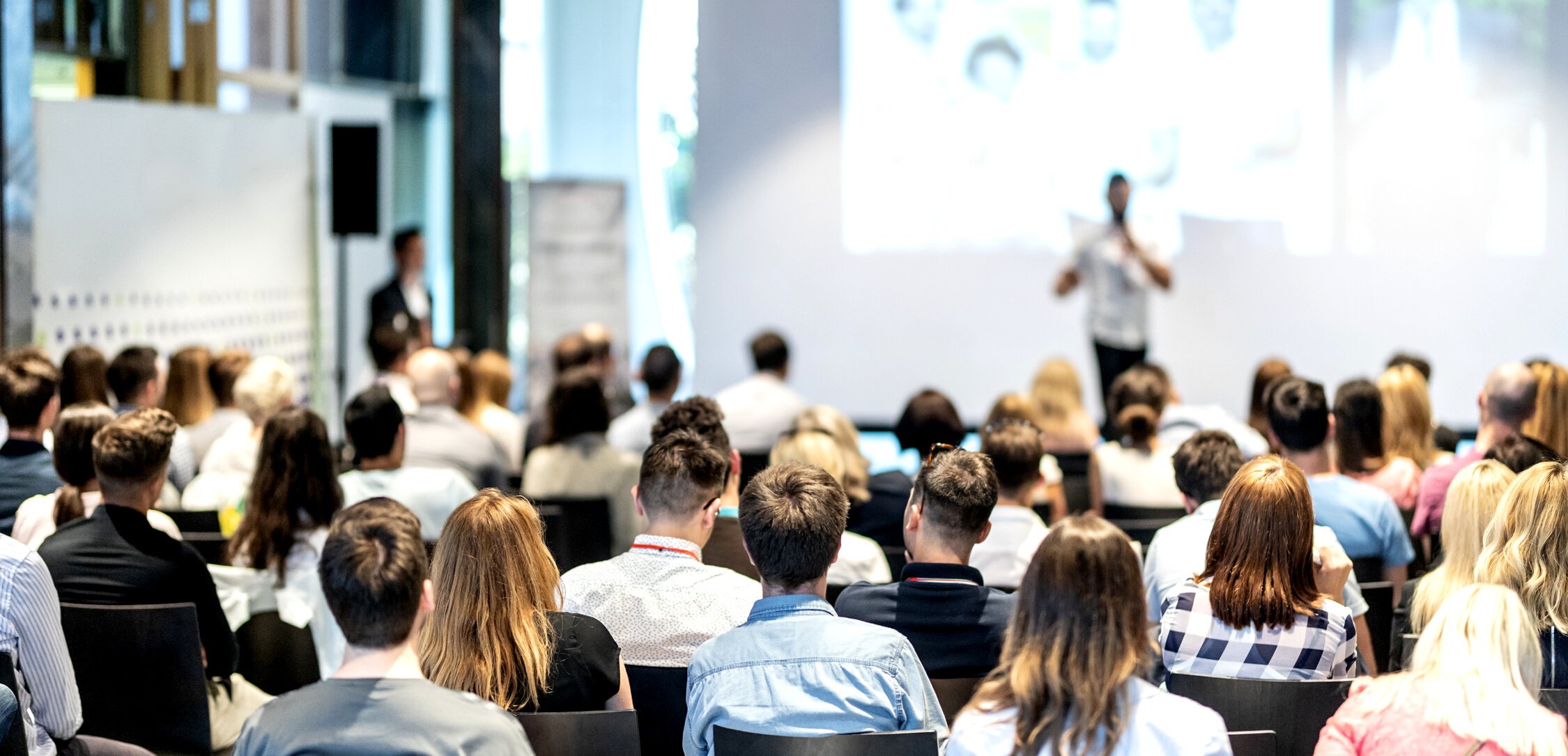 Audience Listening to a Speaker on the Stage